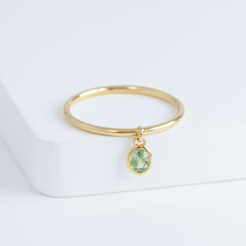 Swinging oval green sapphire ring