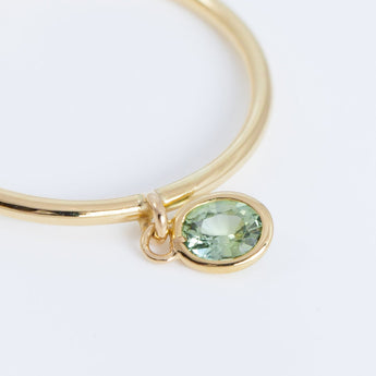 Swinging oval green sapphire ring