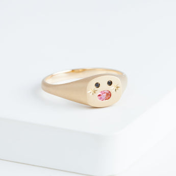 Small oval mouth face signet ring with sparkly cheeks