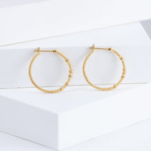 Load image into Gallery viewer, Tying hoop earrings with diamonds

