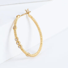 Load image into Gallery viewer, Tying hoop earrings with diamonds
