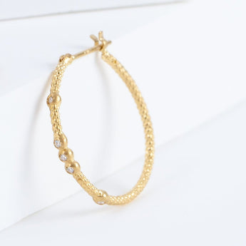 Tying hoop earrings with diamonds