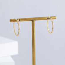 Load image into Gallery viewer, Tying hoop earrings with diamonds
