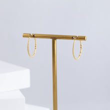 Load image into Gallery viewer, Tying hoop earrings with diamonds
